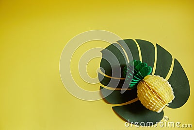 One pineapple made of paper on a yellow isolated background. Horizontal photo Stock Photo
