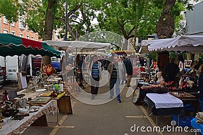 Vanves flea market on early Saturday morning with vendor setting up stalls in Paris, France Editorial Stock Photo