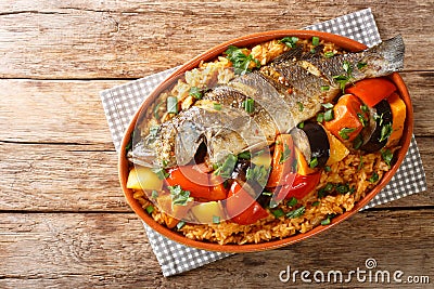 One-pot Thieboudienne Traditional West African Fish and Rice Dish with vegetables closeup in the dish. horizontal top view Stock Photo