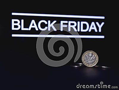 One Pound Coin and BLACK FRIDAY words. British money. Pound coins image. Sale concept. Seasonal sale, Black Friday. Sale of the Ye Stock Photo