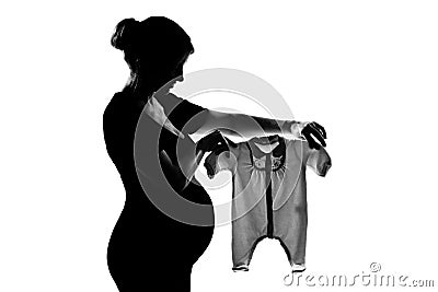 One pregnant woman holding baby clothes Stock Photo