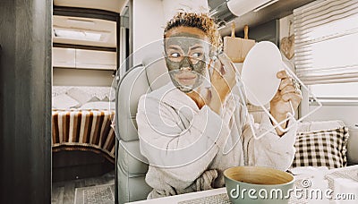 One pretty adult young woman busy in daily skin face care routine using natural green mask for wrinkles and halthy eyes holding a Stock Photo