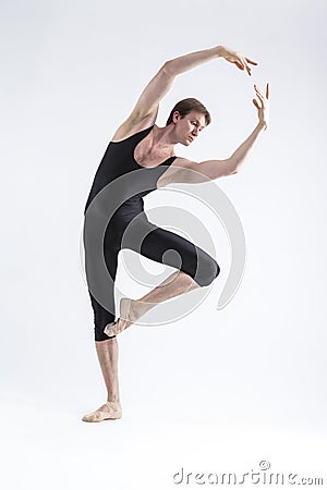 One Professional Male Ballet Dancer Young Man in Black Dance Tights Suit Posing in Ballanced Dance Pose in Studio Stock Photo