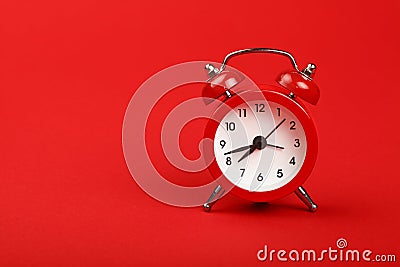 One red alarm clock over red background close up Stock Photo