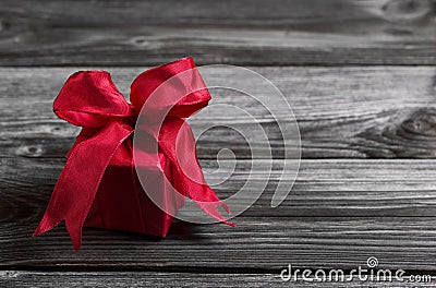 One red festive christmas present on wooden shabby background. Stock Photo