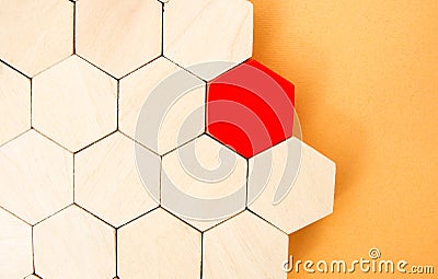 One red hexagon stands out from the rest. Leadership and victory concept. Dissimilarity and dissent. Uniqueness initiative. Stock Photo