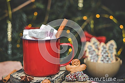 One red iron mug with hot cocoa, marshmallows on top with cinnamon,. Stock Photo