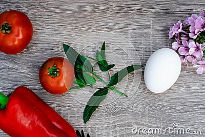 one red pepper. two tomatoes and one egg, violet, mint, objective photography Stock Photo