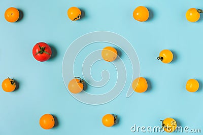 One red tomato cherry stand out from yellow tomatoes cherry. individuality and difference concept Stock Photo