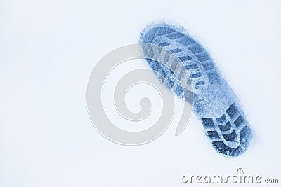 One right foot shoe print on snow, top view, copy space, cloudy Stock Photo