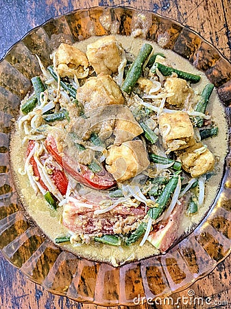 one serving of traditional Indonesian food, gado-gado consisting of chopped vegetables and smothered in peanut sauce Stock Photo