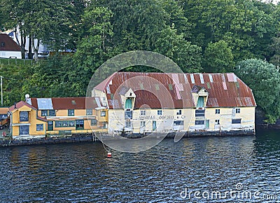 One of several old Waterfront Warehouse Buildings on its own private Stone Quay on the Waterfront at Bergen. Stock Photo
