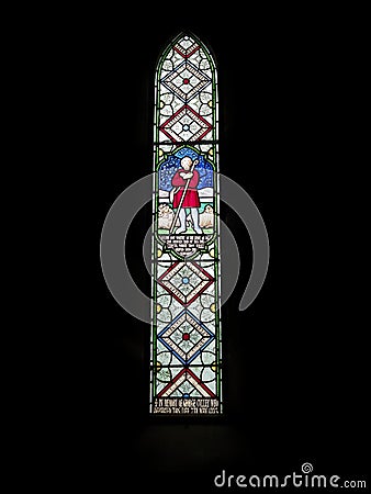 One of several Victorian Stained Glass Windows within the Church of St Michael and All Angels next to Ford Castle. Editorial Stock Photo