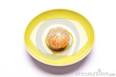 One shelled mandarin on saucer Stock Photo