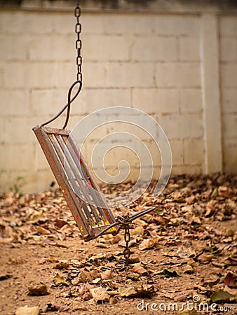 One side of the broken iron swing Stock Photo