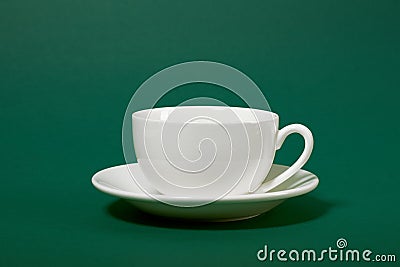 One simple coffee cup on green color background, closeup photo Stock Photo