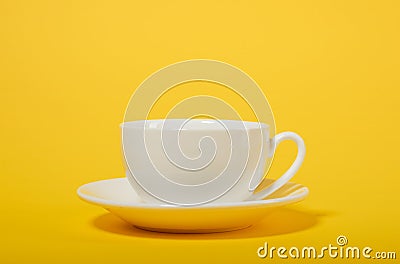 One simple coffee cup on yellow color background, closeup photo Stock Photo