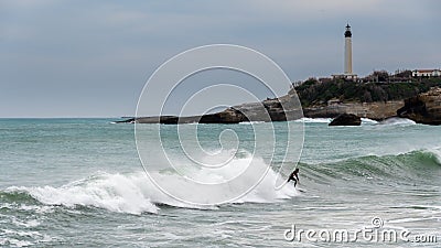 Surfer surfing a wave in Biarritz, France Editorial Stock Photo