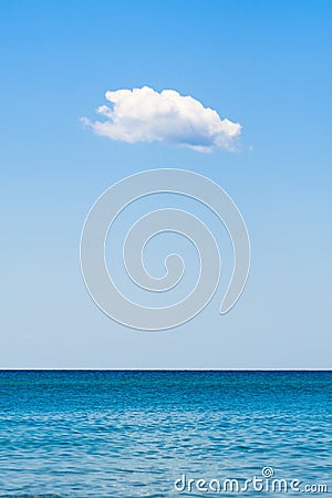 One small cloud over the sea. Vertical frame. Stock Photo