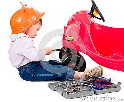 One small little girl repairing toy car. Stock Photo