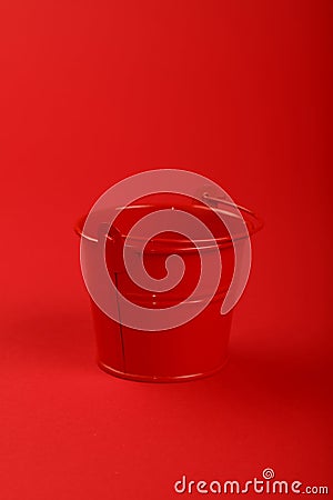 One small metal bucket on red background close up Stock Photo