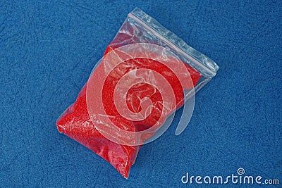 One small plastic bag with red sand Stock Photo