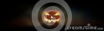 One spooky evil halloween lantern, Jack O Lantern, with glowing eyes and face. Stock Photo