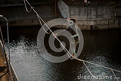 One sportsman walk and balanced on stretched sling. Stock Photo