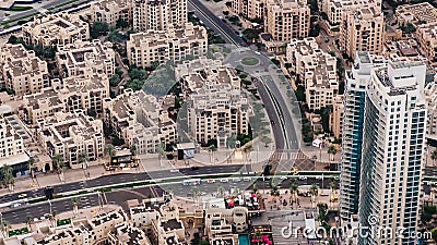 One-story cottages, skyscrapers and other buildings of Dubai from the height of bird flight. Panorama of the city. Time. One-story cottages, skyscrapers and stock footage One-story cottages, skyscrapers and other buildings of Dubai from the height of bird flight. Panorama of the city. Time. One-story cottages, skyscrapers and stock footage