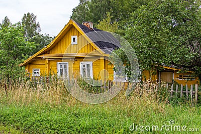 One-story wooden house in the countryside..Old yellow village building, front view Stock Photo