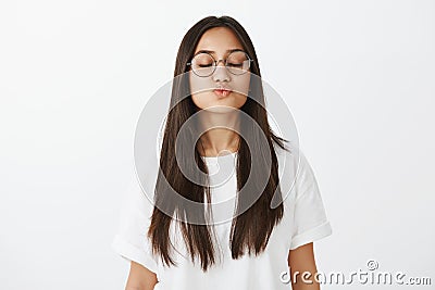 One sweet kiss from prince charming. Portrait of good-looking romantic woman with tanned skin in stylish glasses, giving Stock Photo