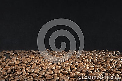 one third of freshly roasted brown coffee beans with two thirds Stock Photo