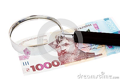 One thousand hryvnias and a magnifying glass, isolated Stock Photo