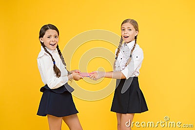 One for two. childrens literature. outraged classmates with workbook. little girls in school uniform. girls can`t share Stock Photo