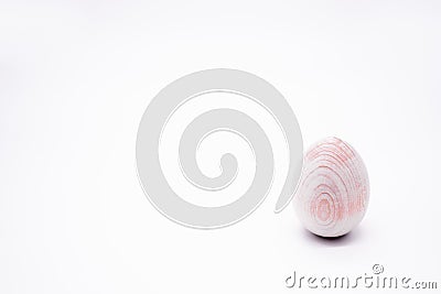 One unpainted hand-made wooden egg on a white background. Copy space Stock Photo