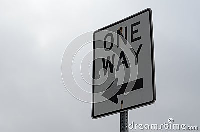 One way sign under a cloudy sky Stock Photo