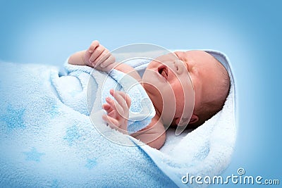 One week old crying baby in blanket on white background Stock Photo