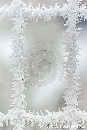 One window in mettalic mesh covered by frozen snow crystals Stock Photo