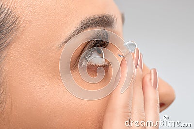 One woman holds contact lens on her finger. Eye care and the choice between the means to improve vision Stock Photo