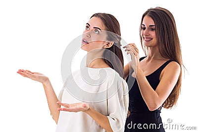 One woman making another one a plait Stock Photo