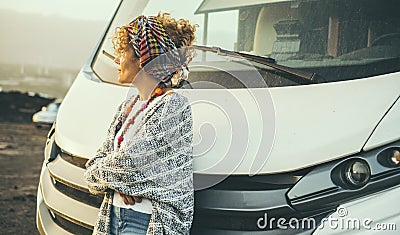 One woman tourist against a modern big camper car motor home alternative house and vehicle for travel and enjoying vacation. Stock Photo