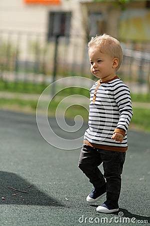 One year old baby boy toddler at playground Stock Photo