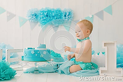 A one-year-old boy tries his first birthday cake. Anniversary Party Stock Photo