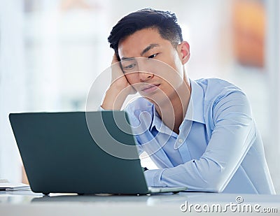 One young asian business man looking bored, tired and demotivated while waiting on slow laptop connection error. Lazy Stock Photo