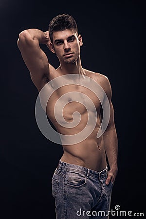 One young man, fit abs body shirtless jeans Stock Photo