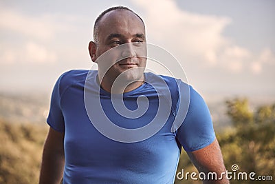 One young overweight man, 30-35 years, looking sideways, upper body shot. Stock Photo