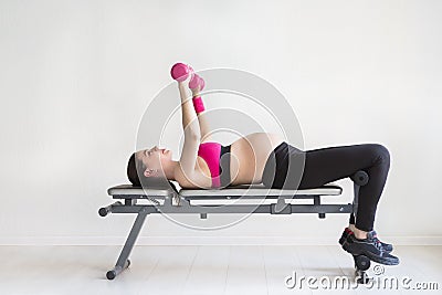 One young pregnant woman doing fitness exercises Stock Photo