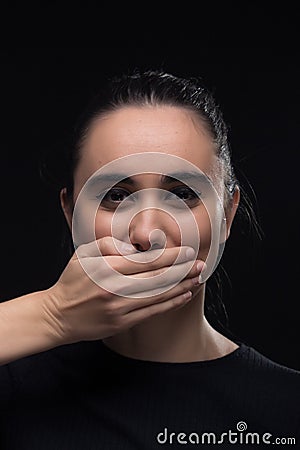 One young woman, hand covering mouth, smiling Stock Photo