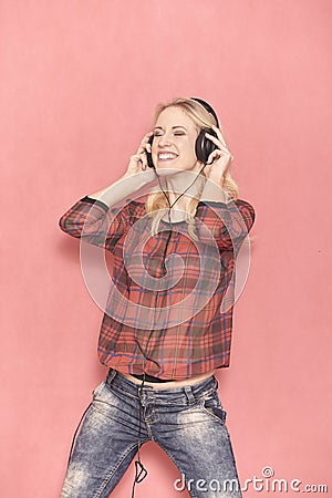 One young woman, hilarious laughing emotion, hilarious listening to music on headphones. Stock Photo