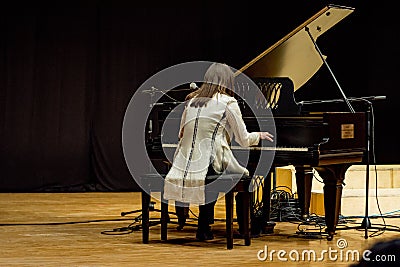 One woman plays piano in a concert Editorial Stock Photo